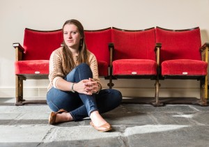 Katie Hale sitting in front of theatre seats