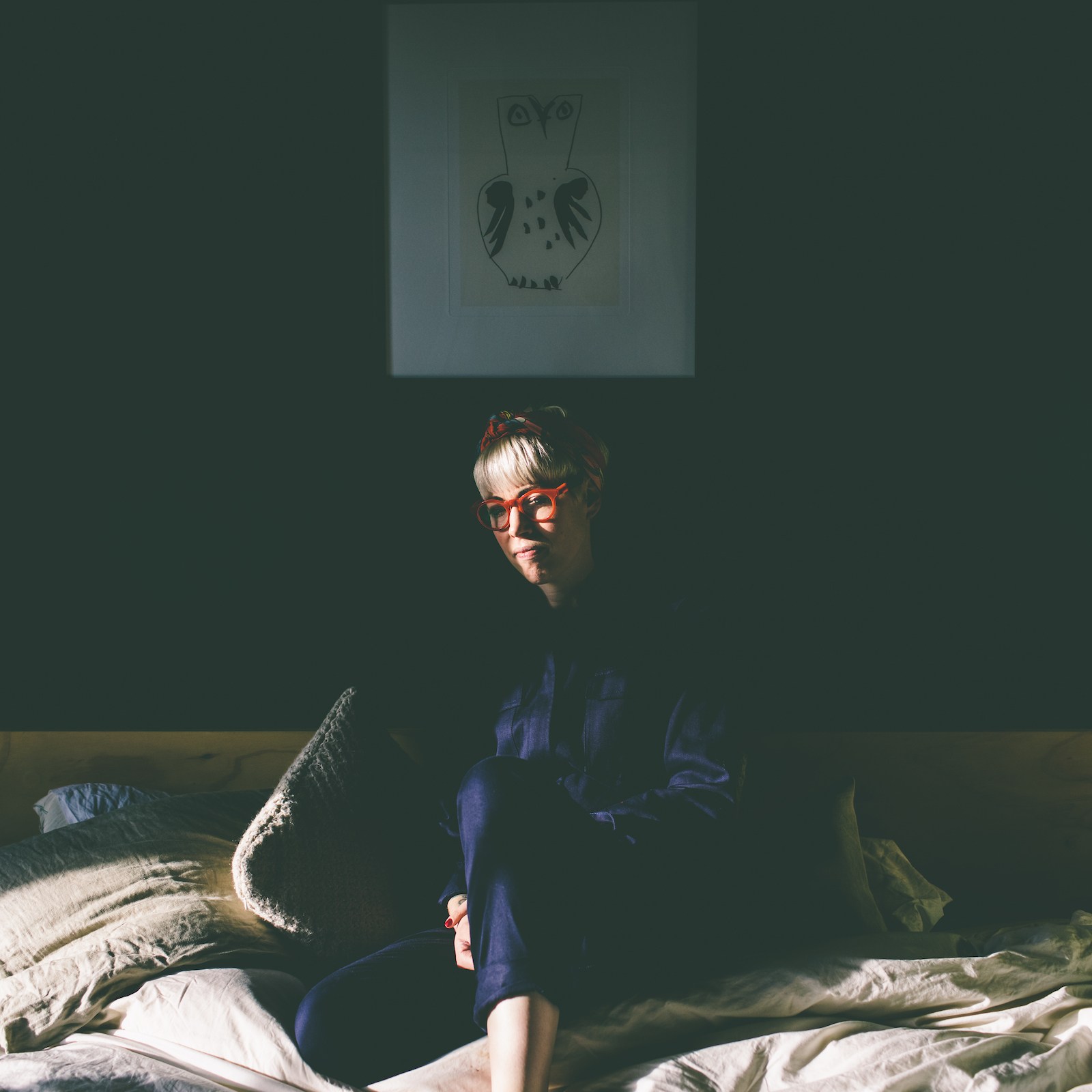 Helen Mort sitting in a shadowy room