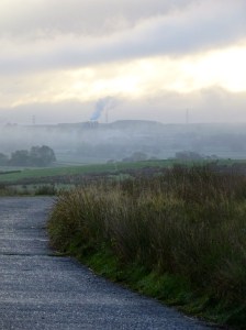 misty morning with a road leading across the fells